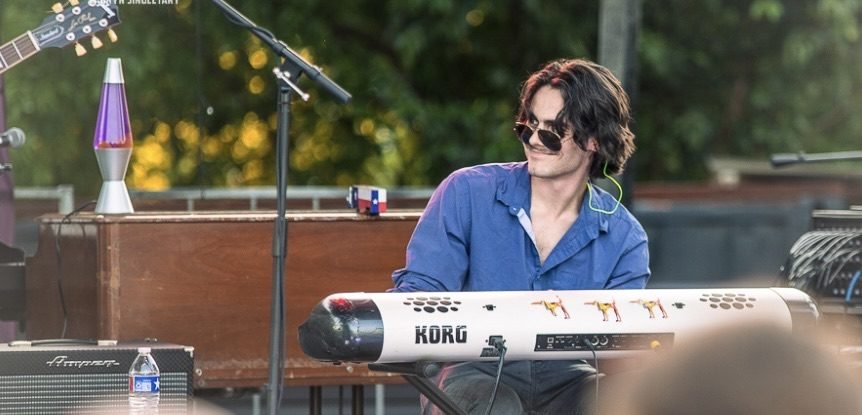 Finn Dickens at the keys on an outdoor stage